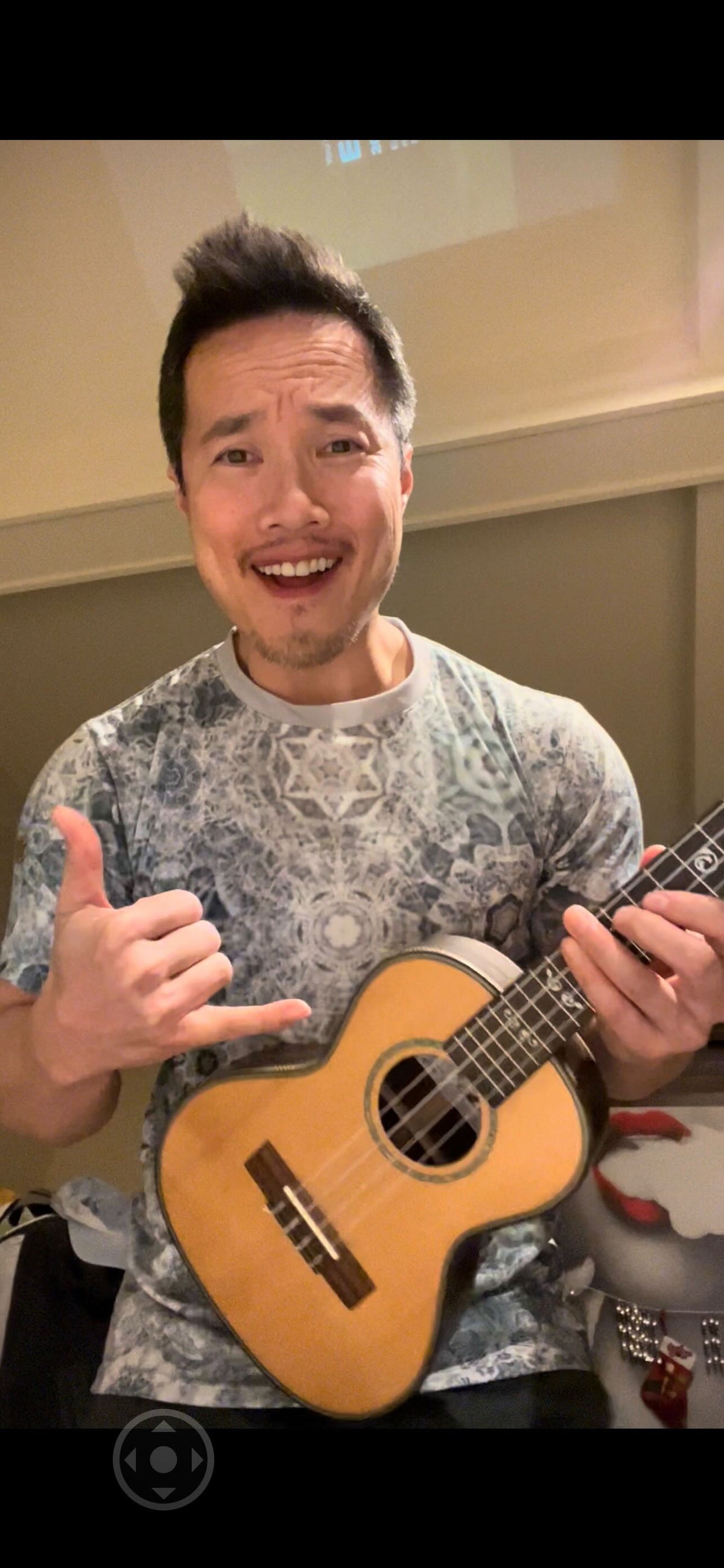 A musician playing guitar in a Galaxy Frog shirt